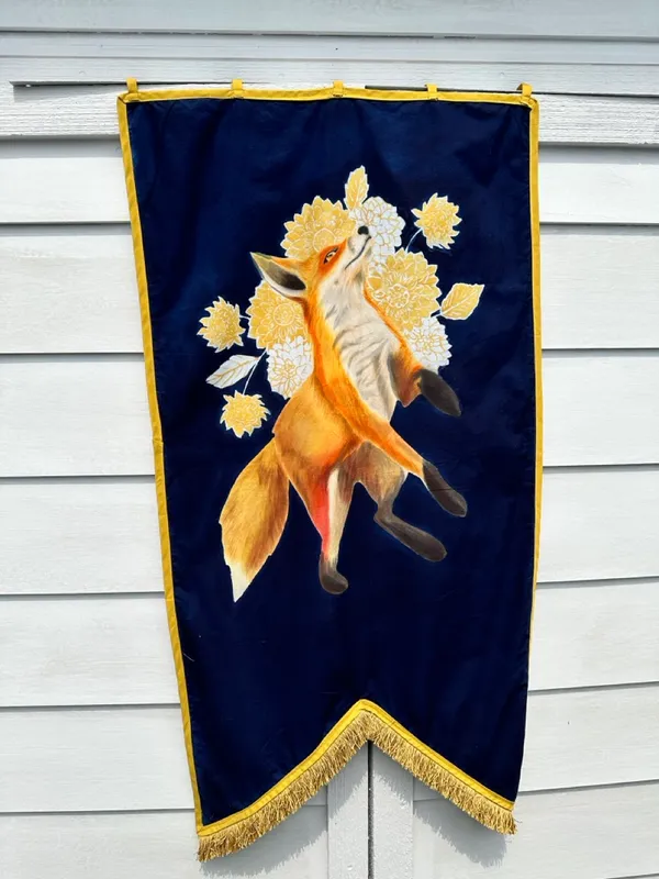 leaping fox over field of gold and white flowers on a navy banner