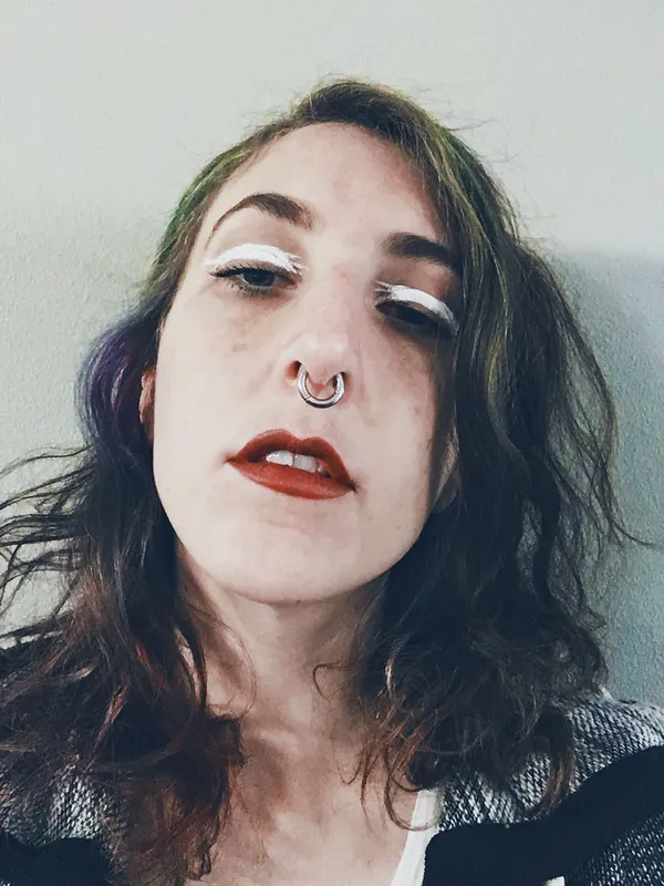 Bold white paint-stroke like eyeliner with bold red lip