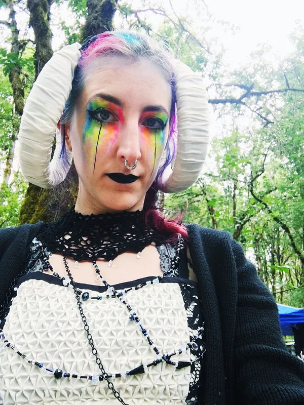 Dripping fluourescent rainbow and black eyemakeup paired with sorceress costume
