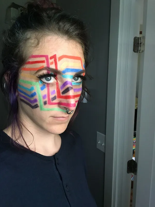 a rainbow-line visual representation of a sort algorithm across Stephanie's face