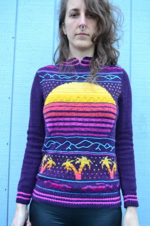 Sweater with a synthwave setting sun, palm trees, and little corvettes