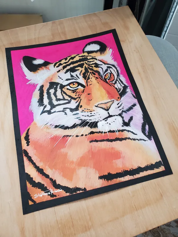 Zoomed out view of tiger painting on a table
