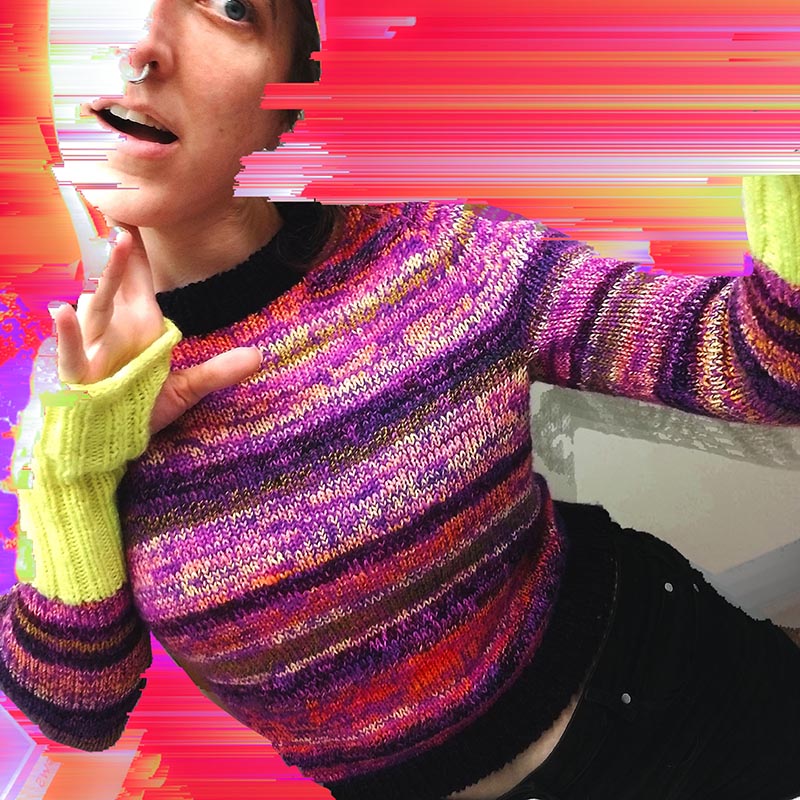 a brightly striped purple, neon yellow, and orange sweater